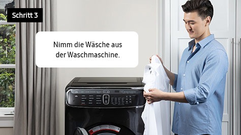 3. Nimm die Wäsche aus der Waschmaschine.