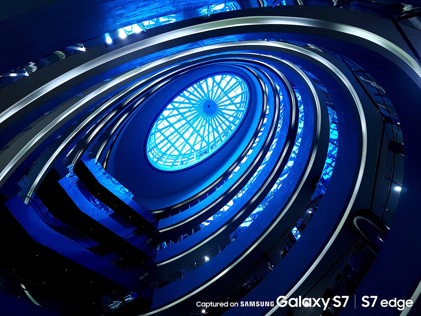 photo of a curvy structure covered in different coloured lighting taken by Galaxy S7.