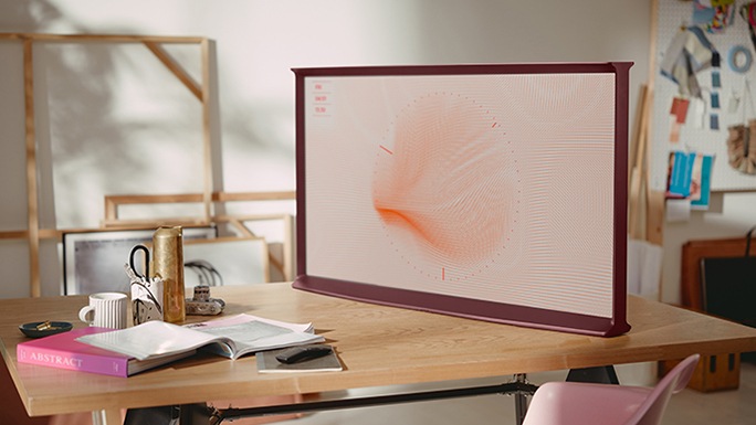 The Serif is on the table with ambient mode in a room The Serif et The Frame