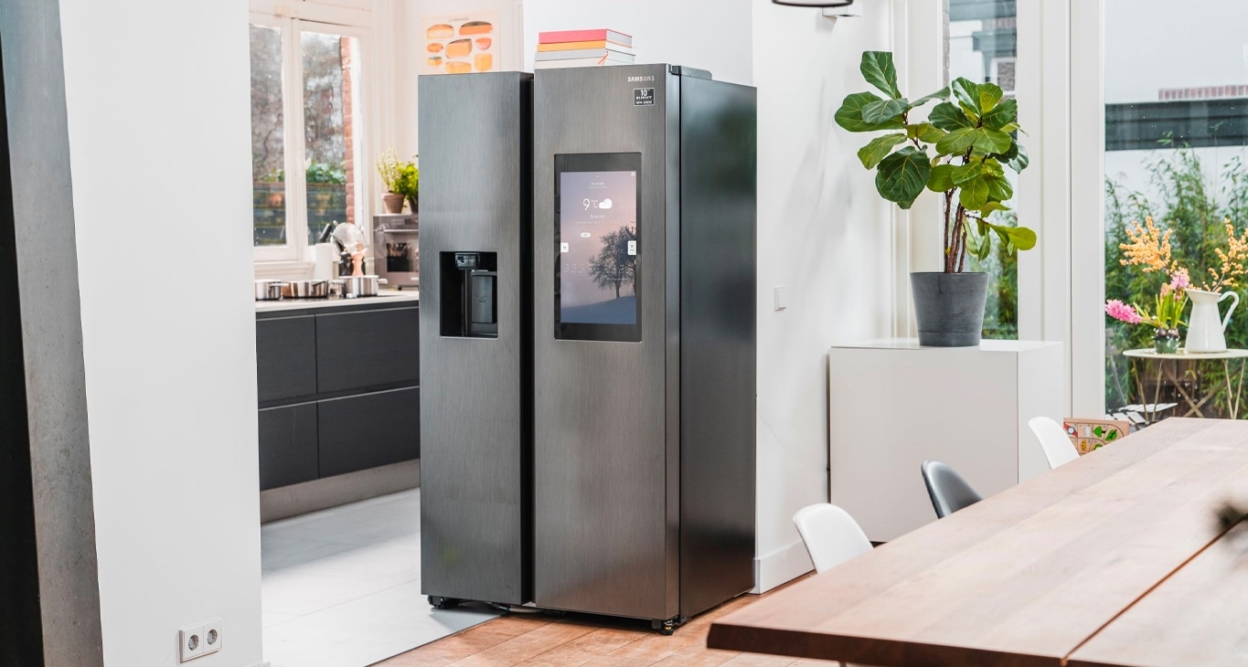 A Samsung kitchen in dark grey, featuring a microwave, dishwasher, fridge and TV samsung family hub