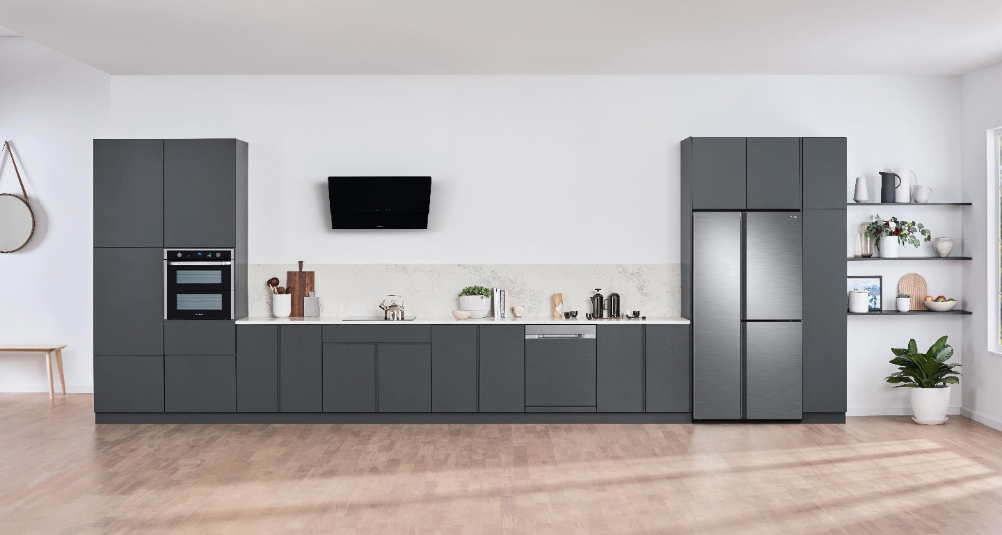 A Samsung kitchen in dark grey, featuring a microwave, dishwasher, fridge and TV A Samsung kitchen in dark grey, featuring a microwave, dishwasher, fridge and TV
