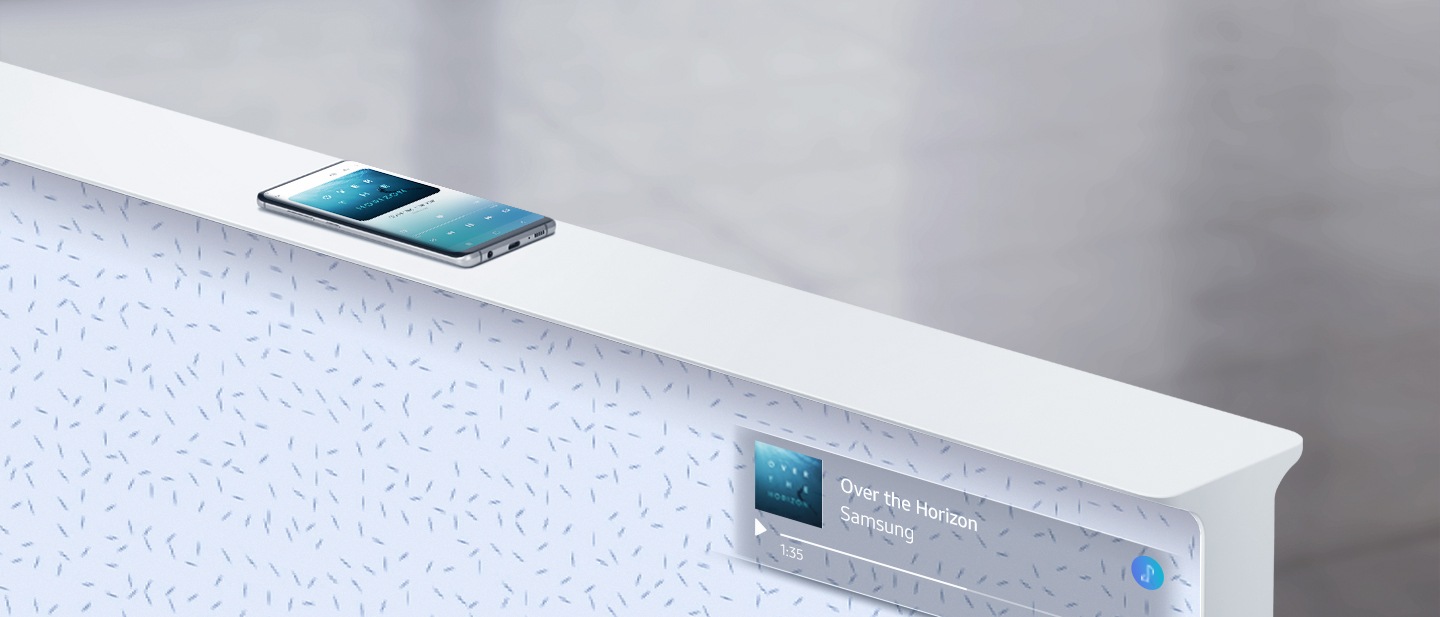 How you can connect The Serif with your Galaxy S10. A woman’s hand places the Galaxy S10 on a White The Serif as graphics show the devices connecting to each other over Bluetooth. Once the two are connected, The Serif mirrors the Galaxy S10 screen playing the song Over the Horizon.