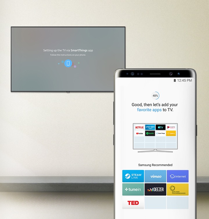 Caption on the TV "Setting up the TV via SmartThing app", caption on the mobile phone "Good, then let's add your favorite apps to TV." with Samsung recommended apps; STEAM LINK, vimeo, Internet, tunein, DEEZER, Berliner Philharmoniker.