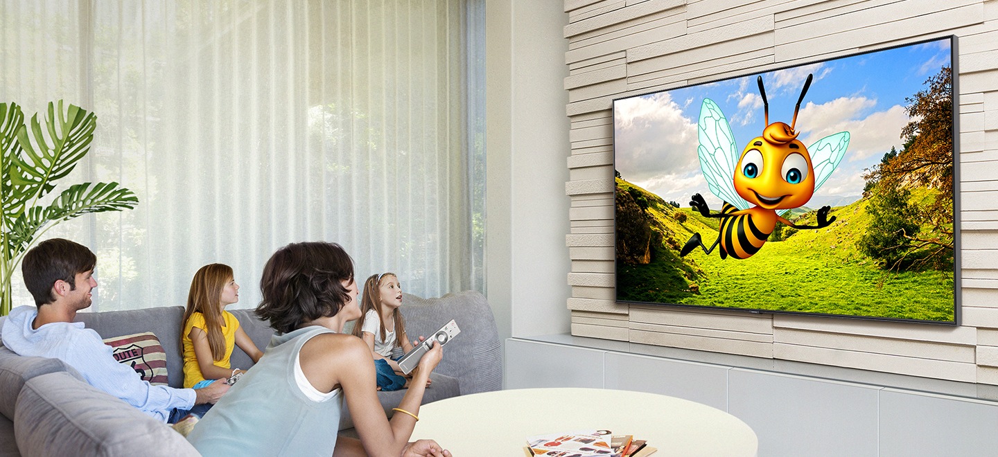 A family is watching YouTube on Samsung Smart TV in the living room. The 3D animation with the bee character is being streamed through YouTube app on Smart TV.