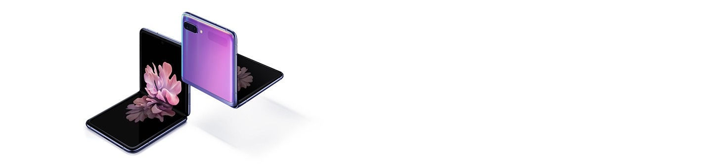 Two Galaxy Z Flip phones in Mirror Purple at a three-quarter angle, one seen from the front and one seen from the rear. Both are folded at right angles with freestop folding. The one seen from the front has the blossoming flower wallpaper onscreen