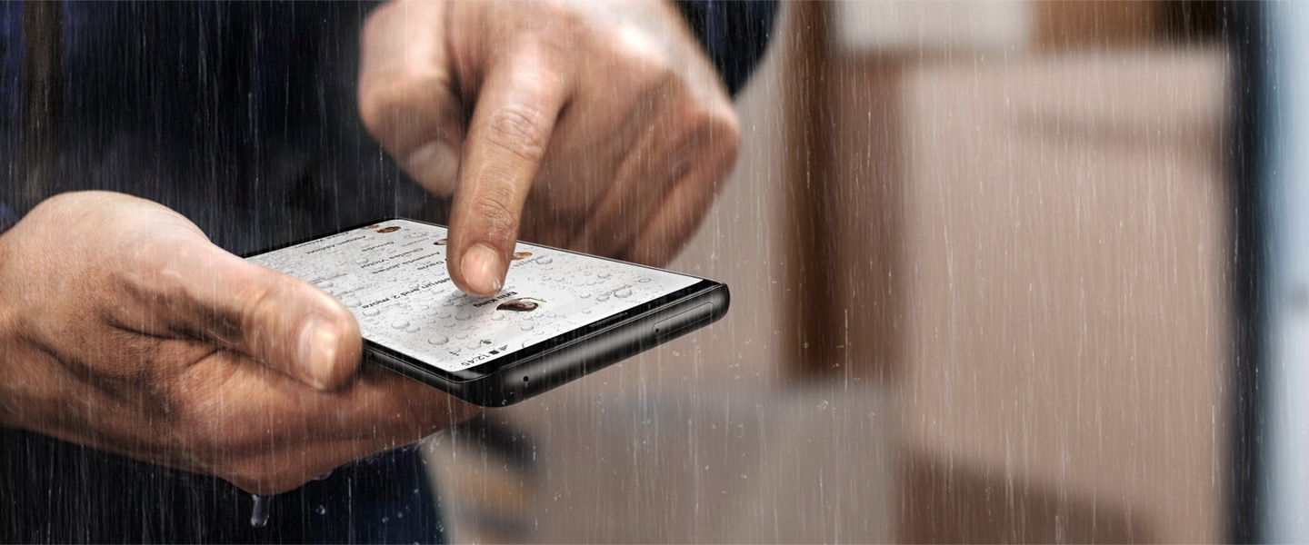 Image of person using Galaxy S9 or S9+ in a rainy situation