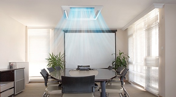 A ceiling cassette air conditioner operating in a conference room
