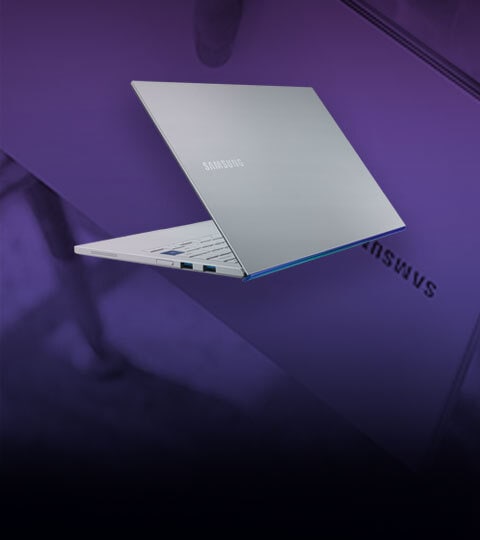 A grey Samsung Galaxy Book Ion laptop stand open with back of the laptop facing forwards in front of a purple background A grey Samsung Galaxy Book Ion laptop stand open with back of the laptop facing forwards in front of a purple background