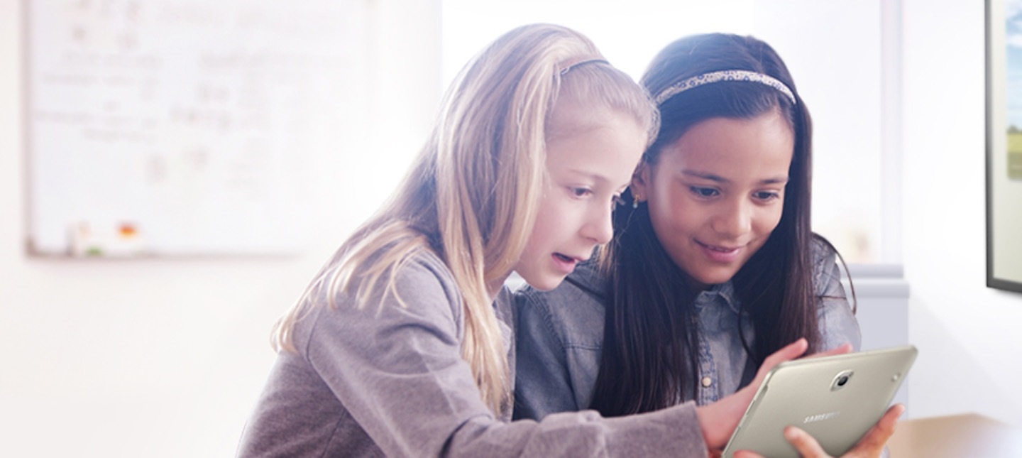 A group of kids drawing on a Samsung E-board at school