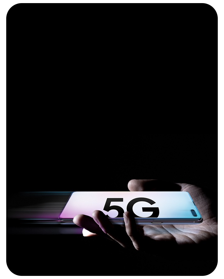 A person holding Galaxy S10 5G in one hand. It is in landscape mode with a gradient wallpaper and text saying 5G onscreen