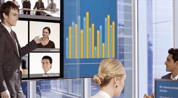 A man presenting a report on the display screen in an executive room