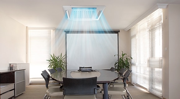 A ceiling cassette air conditioner operating in a conference room