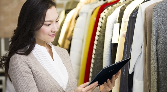 A customer instantly checking further information about clothes using Samsung tablet