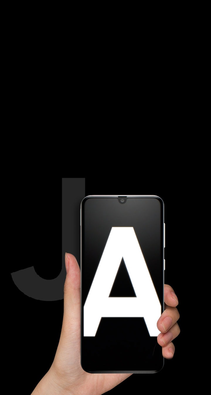 Left hand holding a new Galaxy A device in front of a faded letter J.