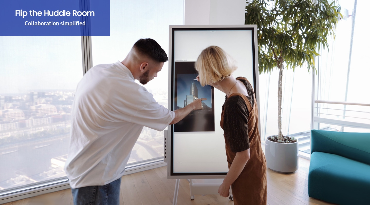 Samsung Flip 2 can share ideas freely in the huddleroom. Two people work together, loading the image by mobile phone NFC tagging and drawing something on the portrait Flip 2 screen.
