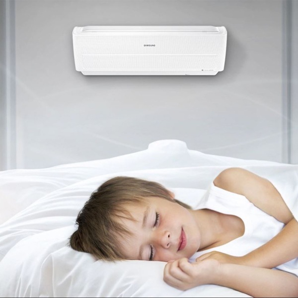 A boy sleeping peacefully with the Samsung Wind-Free Air Conditioner.