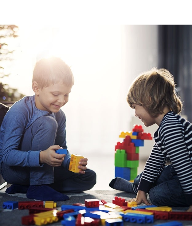 Two boys playing with blocks.
