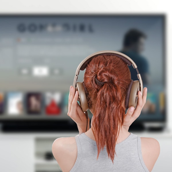 Woman holding her headphone over her head