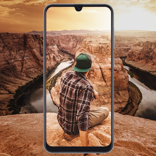 Guy sitting down in the backdrop of a Samsung phone