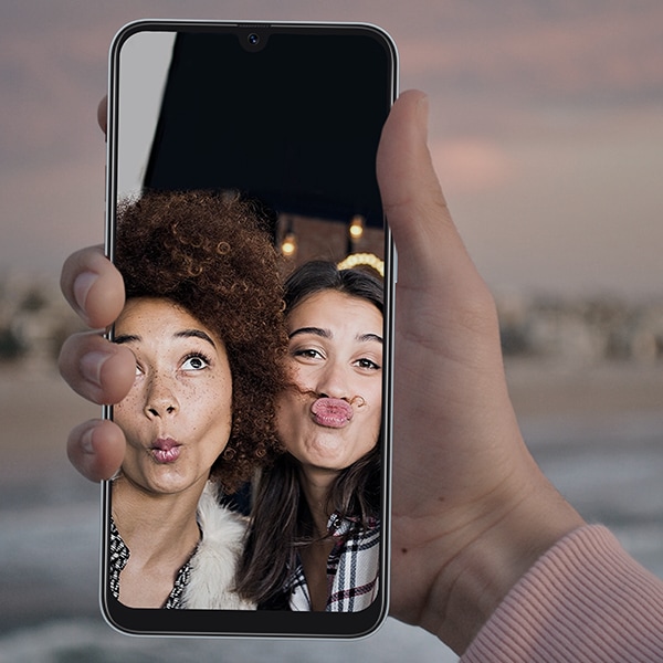 Two girls in the backdrop of a Samsung phone