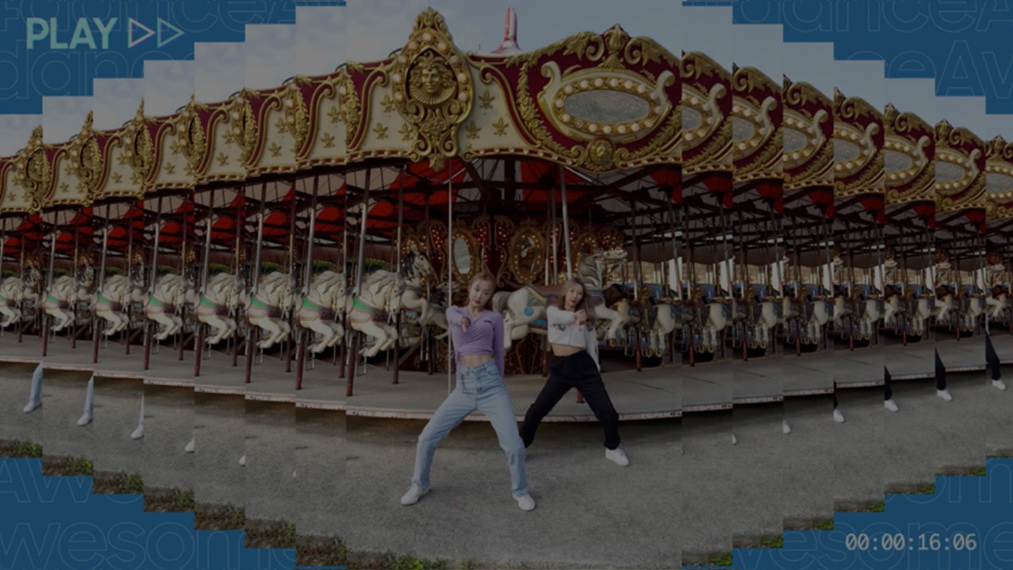 Two dancers appear at center frame. They’re dancing in front of an amusement park carousel ride. Using a Photoshop mirror effect, the layered photo appears as a horizontal pattern. In the background, the words ‘Awesome dance’ also form a word pattern. The word ‘Play’ appears at the top left of the image next to a play video emblem.