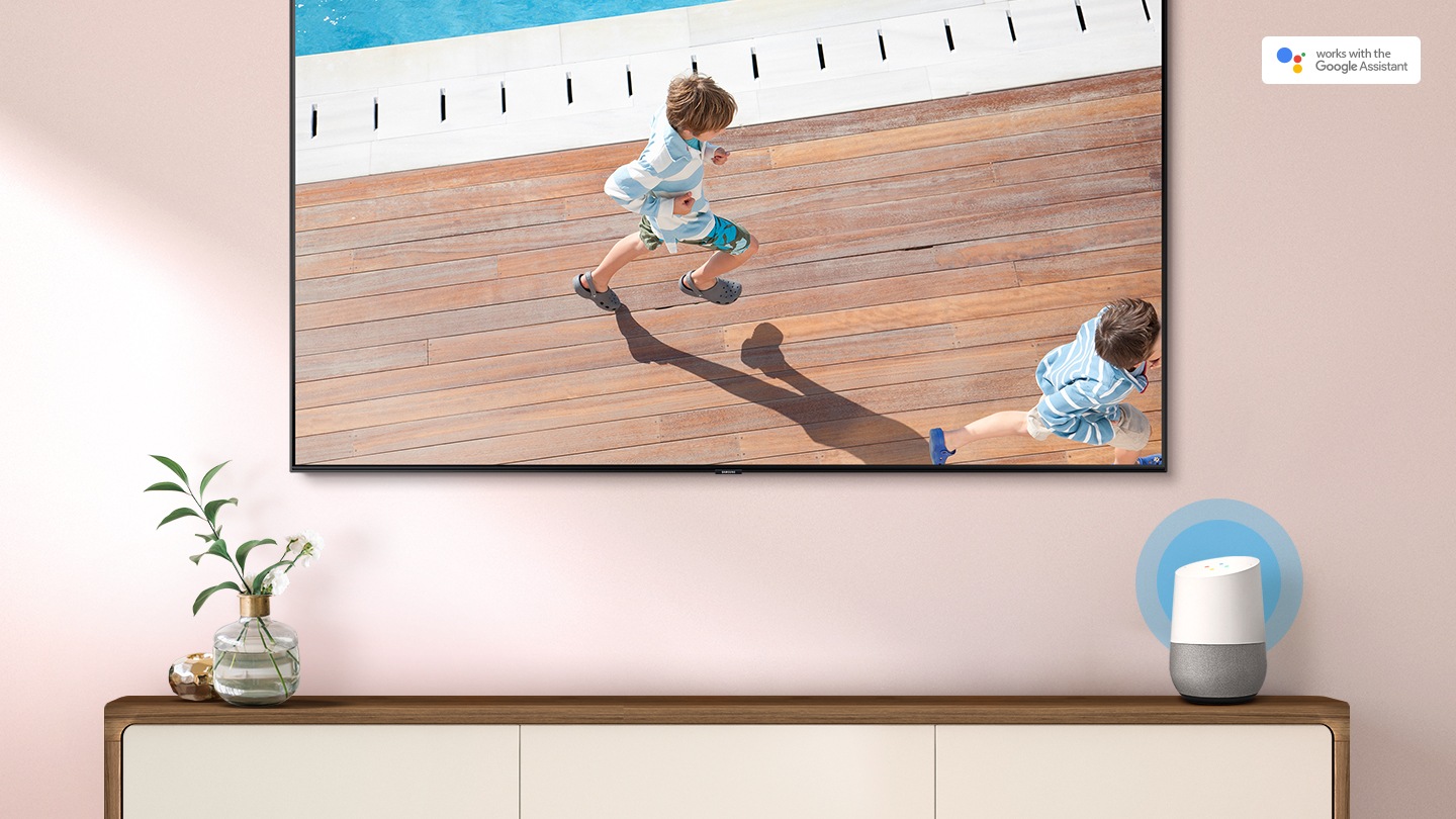 Amazon Alexa & Google Assistant displayed on the tables, connected to a 2019 Samsung Smart TV. TV is showing that children is running.