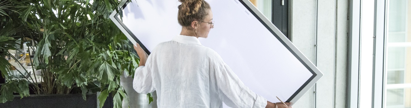 Woman turning the Samsung Flip from vertical stand to horizontal