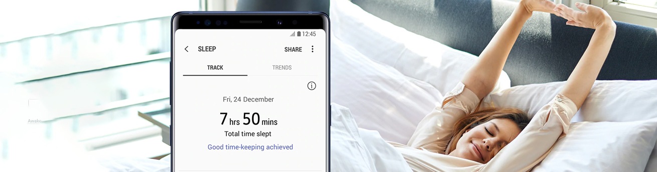 Woman waking up in the background with a close up of the samsung health app