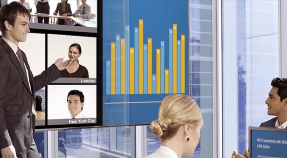 A man presenting a report on the display screen in an executive room