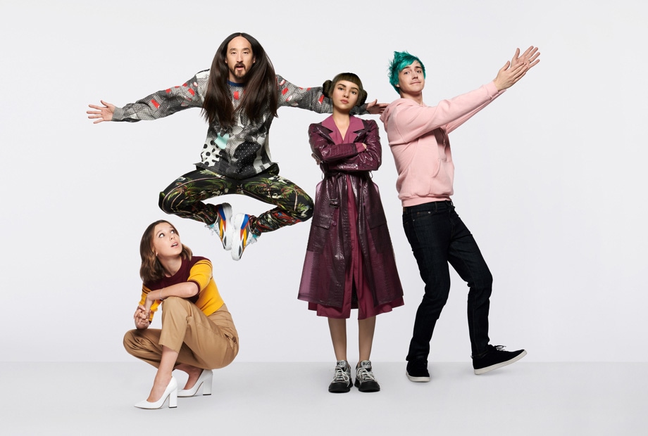 #TeamGalaxy group photo featuring (LTR): Millie Bobby Brown crouching down in white heels as she looks upward to her right, Steve Aoki posing in mid-air with his arms outstretched and feet facing each other inwards, Lil' Miquela stands tall as she folds her arms across her chest and looks confidently straight ahead, Ninja sporting a pink hoodie as he extends his arms to the right side and stands with his left foot pointing outwards.