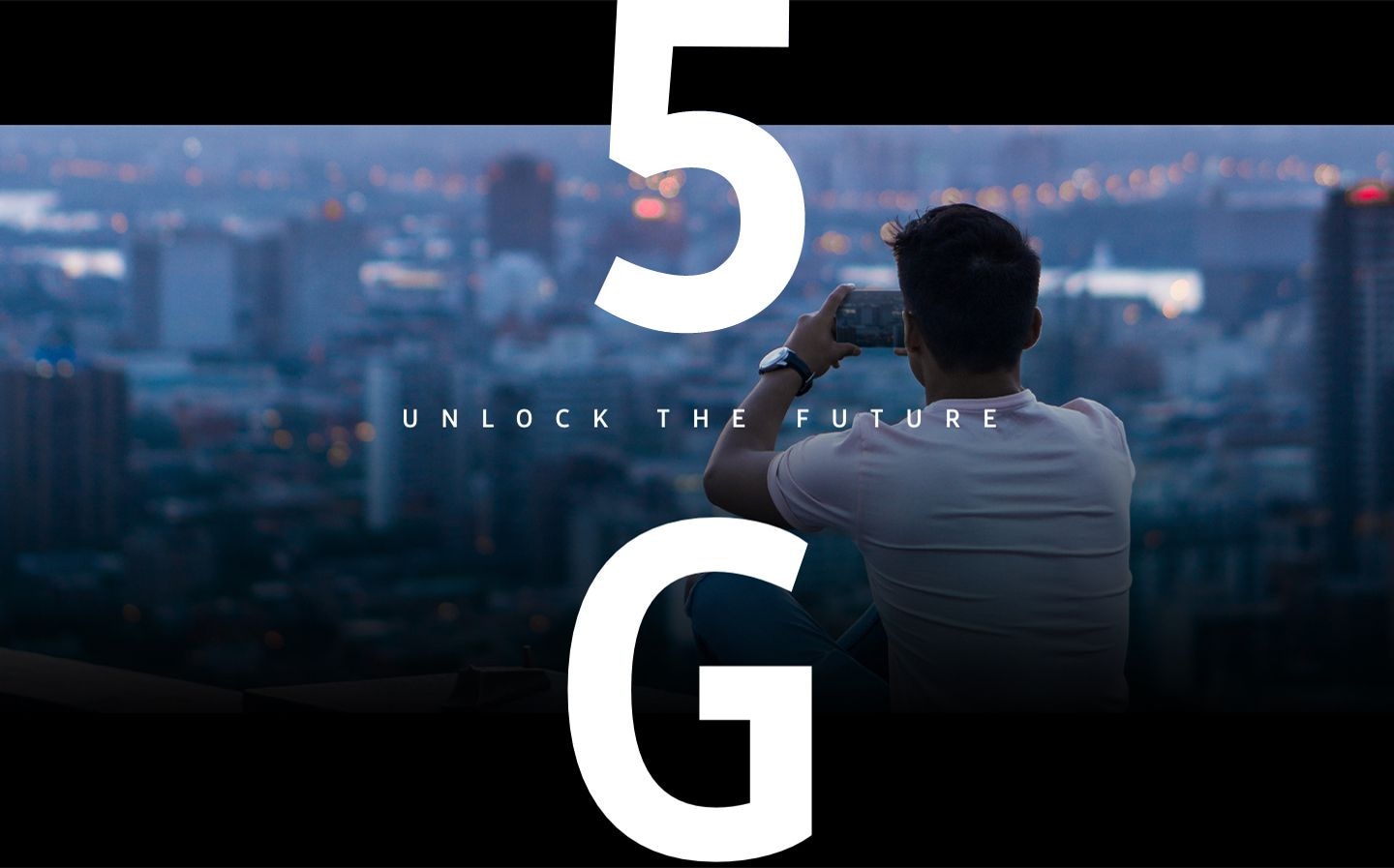 'Man taking a photo of a cityscape with his Galaxy 5G smartphone. Overlaid on the image is text that says 5G unlock the future.