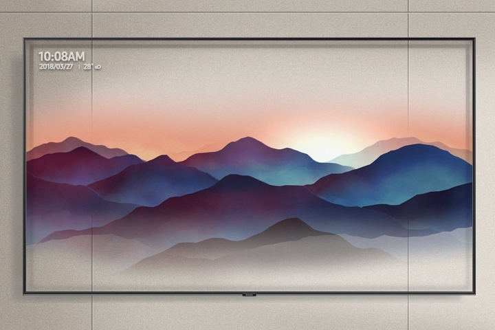 Super Big TV hung on a grey-toned wall is showing décor mode of the Ambient Mode. The semi-transparent image of mountains is well harmonized with the color and texture of the wall.