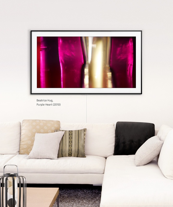 The Frame hanging on a wall surrounded by black and white décor with the basic charcoal black frame.