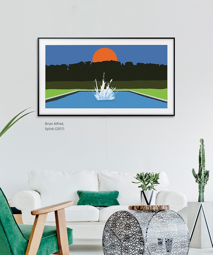 The Frame hanging on a wall in a living room above a white couch and plants with the basic charcoal black frame.