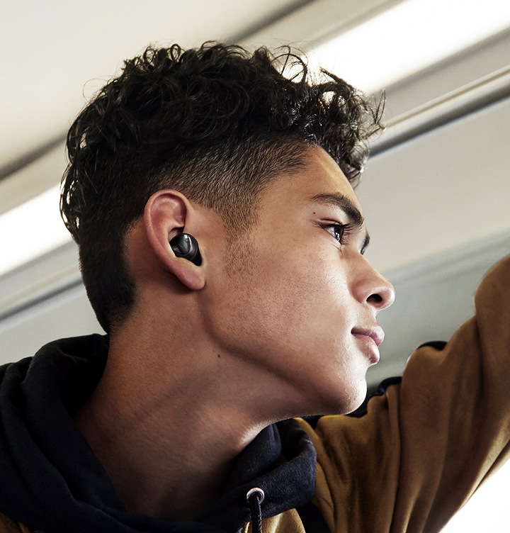 Um homem a olhar para o lado, com uns Galaxy Buds pretos