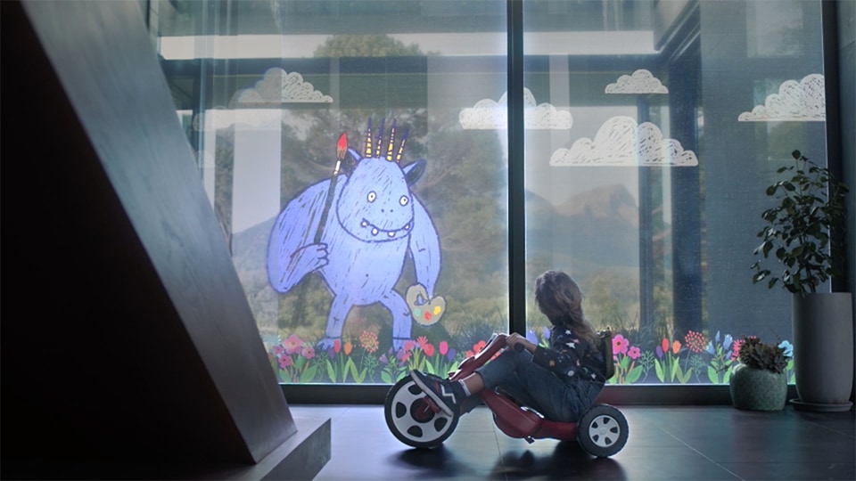 a girl is watching cute monster image on the window