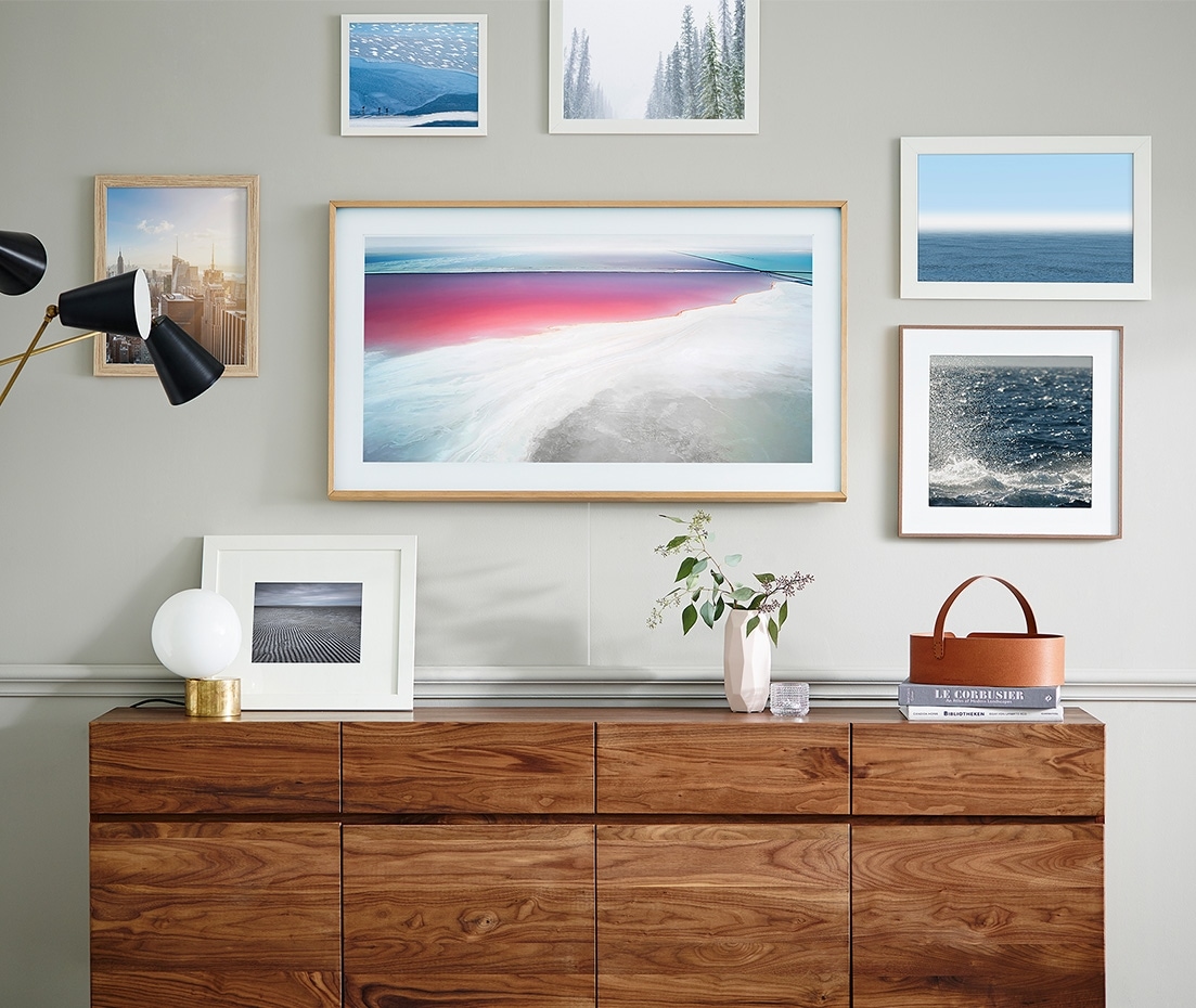 The Frame on the wall displaying artwork among other picture frames.