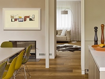 The Frame from afar as it hangs on the wall of dining room above a fireplace and next to entrance to living room.