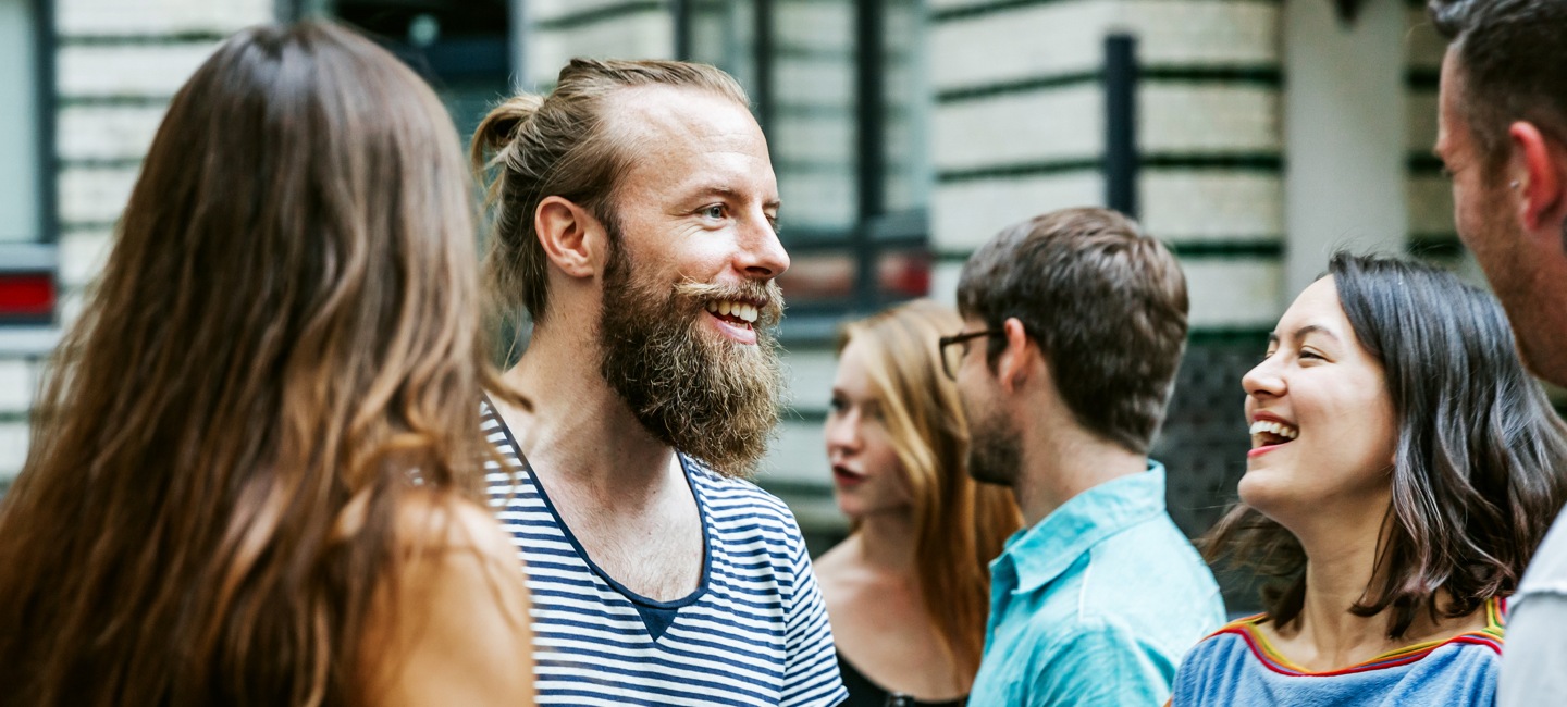 Group of friends chatting outside about time saving tips