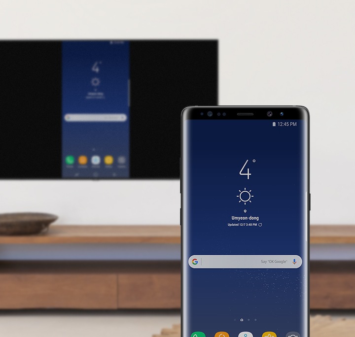 Mobile Phone and Smart TV sharing a same screen; mobile phone's home screen displayed on the Smart TV.
