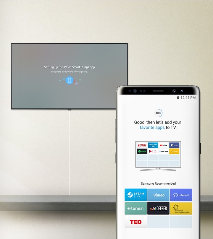 Caption on the TV "Setting up the TV via SmartThings app", caption on the mobile phone "Good, then let's add your favorite apps to TV." with Samsung recommended apps; STEAM Link, vimeo, Internet, tunein, DEEZER, BERLINER PHILHARMONIKER, TED