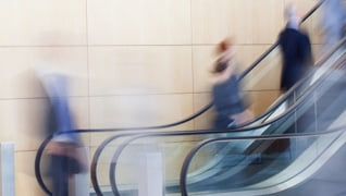 Hyperlapse scene of people going up an escalator.