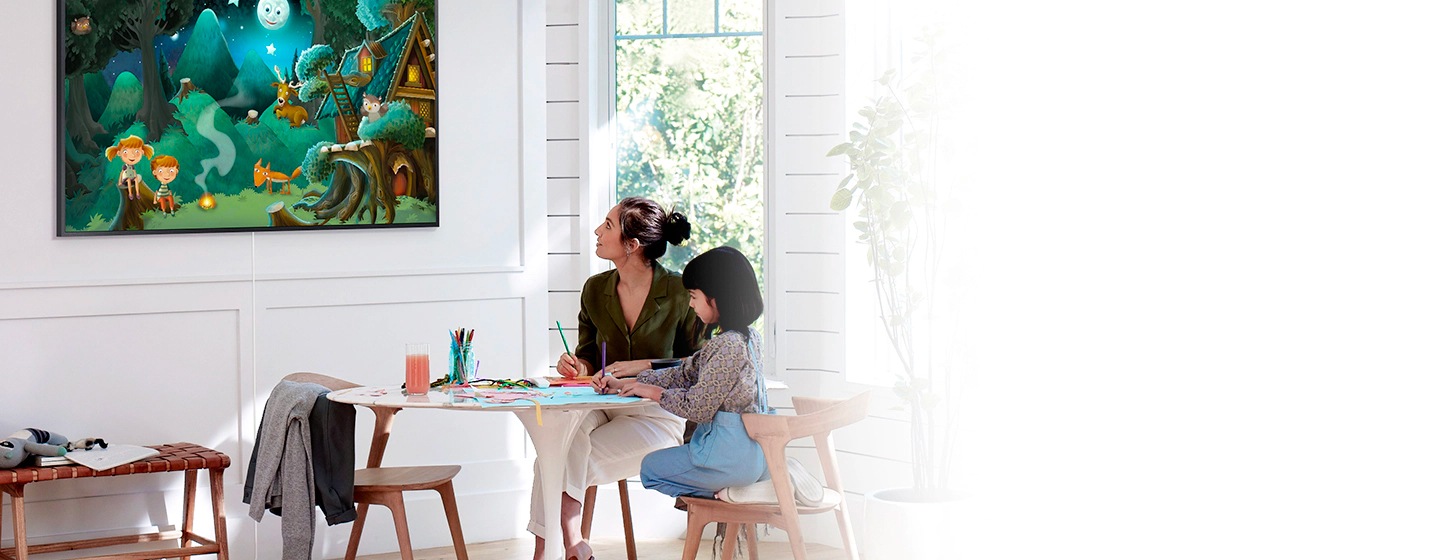 A mother and her child are looking at The Frame TV mounted on the wall. The mother is looking for and finding content using Amazon’s Alexa and the Google Assistant, both of which make it even easier to find your favorite artworks.