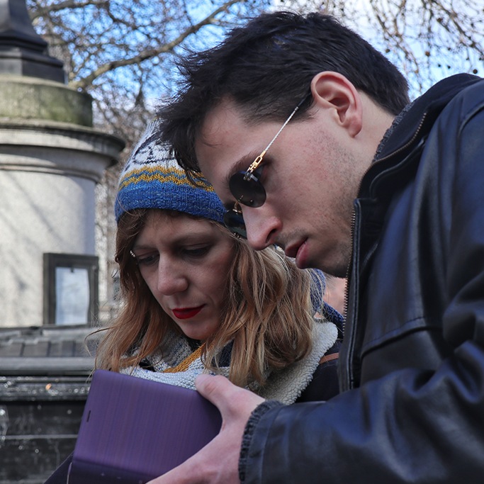 Two people looking at their smartphones