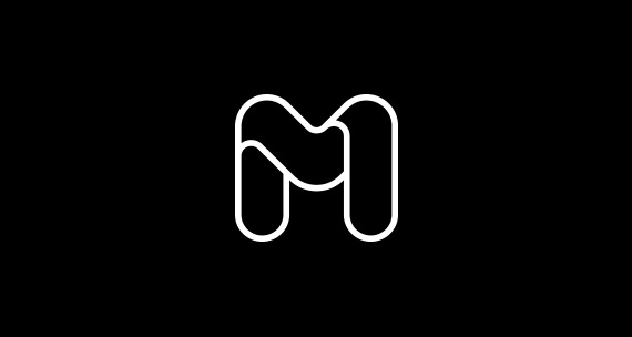 White outline icon of the letter M in bubble font with curved lines within the letter in front of a black background White outline icon of the letter M in bubble font with curved lines within the letter in front of a black background