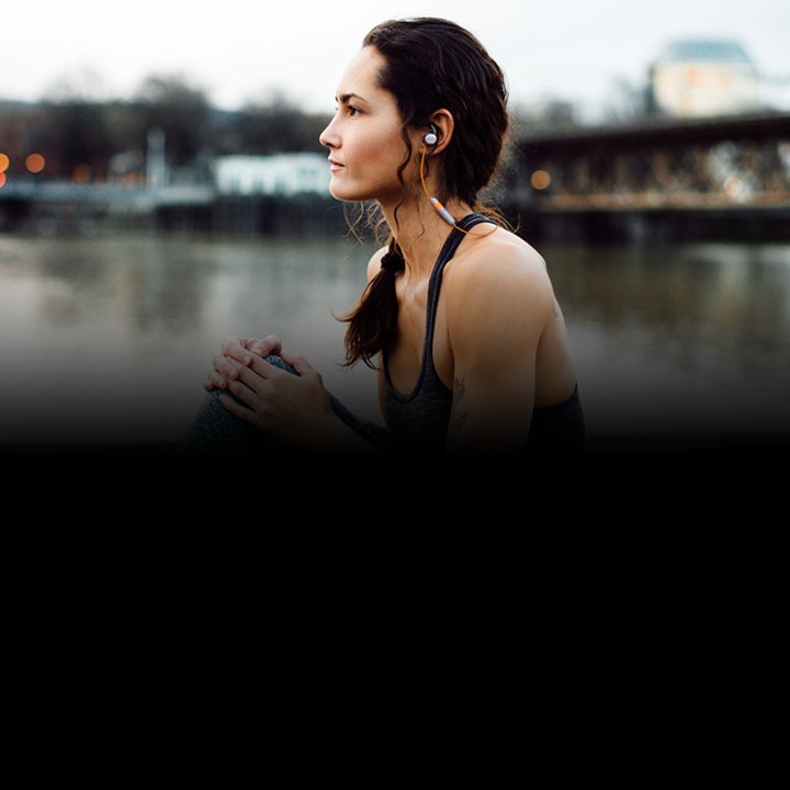 A woman wearing AKG N200 wireless earphones