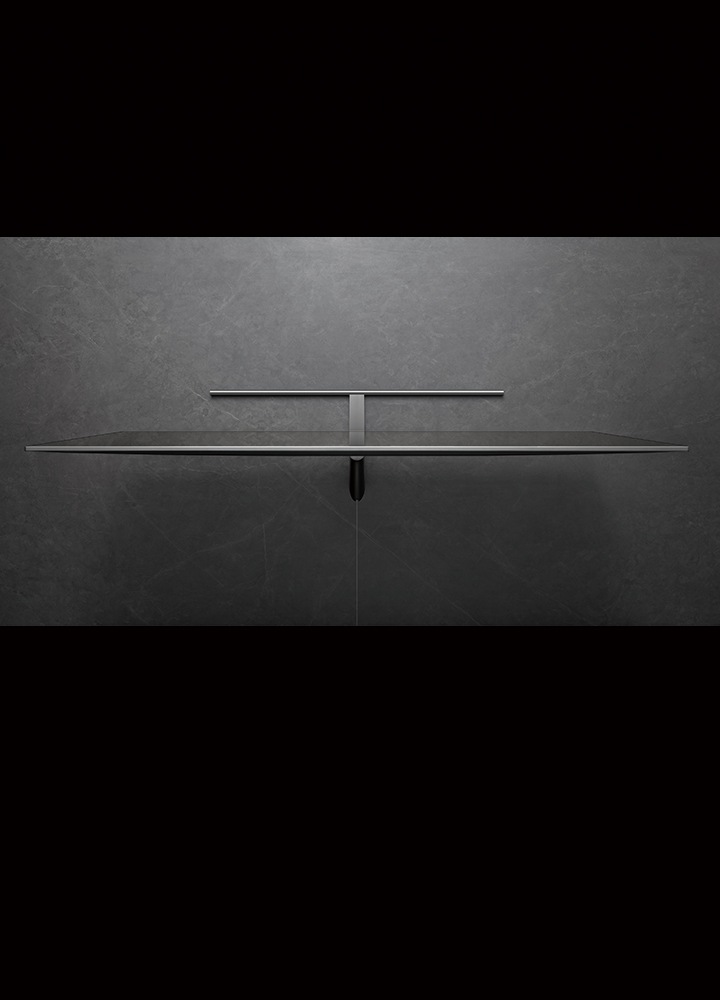 A top view of gray QLED 4K TV with a stand sitting on a gray floor
