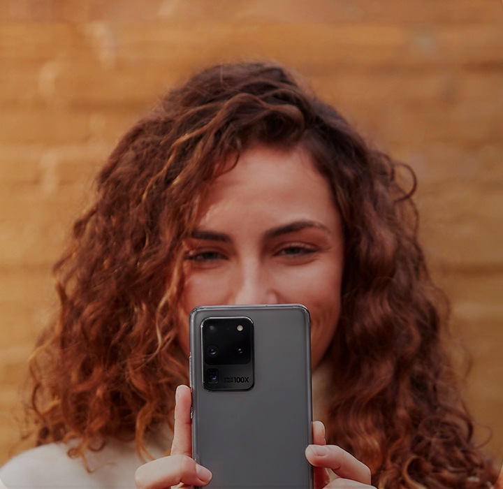 Woman holding her Galaxy S20 phone