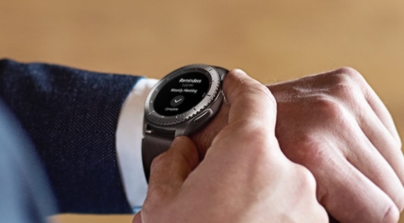 A man in a suit controlling his Samsung Gear