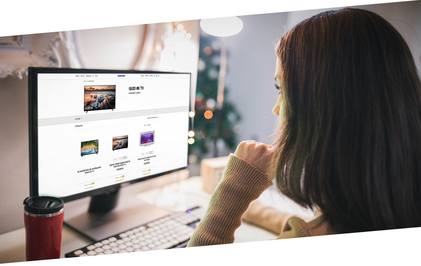 A woman is looking at Samsung official website showing Samsung TV products page on the screen.